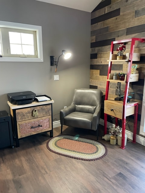 Custom reclaimed wood and steel filing cabinet and shelf with modern lounge chair in Parkhill Ontario